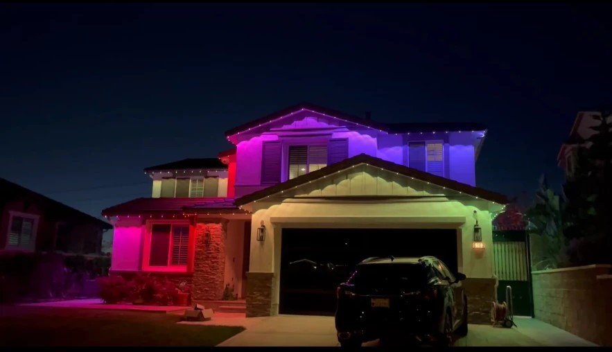 Two-story home with purple, blue and pink permanent LED lighting