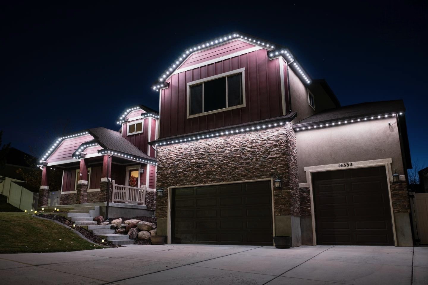 Craftsman home with crisp white permanent LED roofline lighting