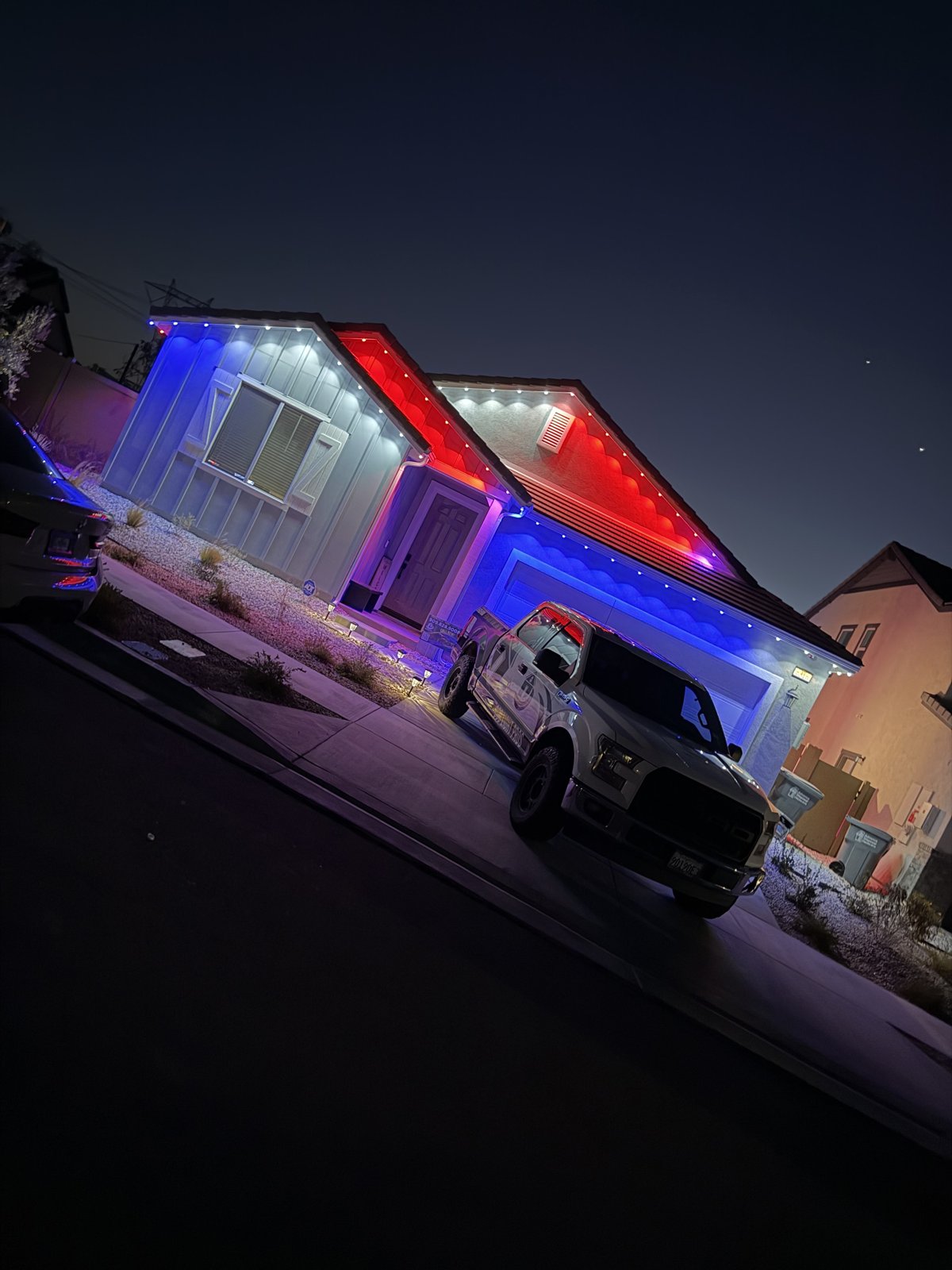 Home with red, white and blue permanent LED lighting for the holiday